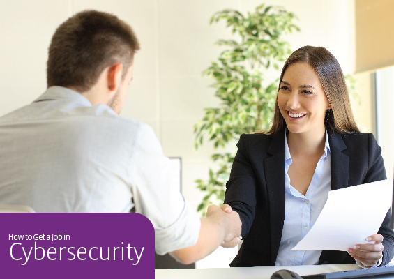 An IT pro shakes hands with a hiring manager during an interview for a cybersecurity job