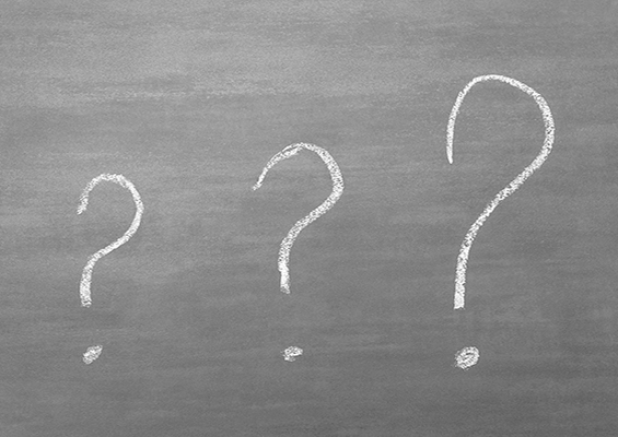 Three question marks drawn on a chalkboard