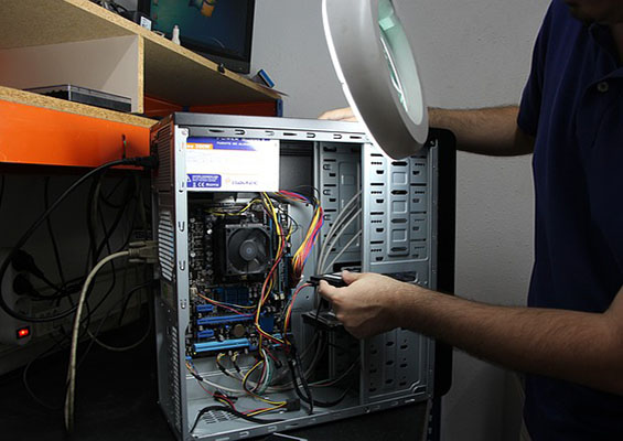 A person repairs a computer