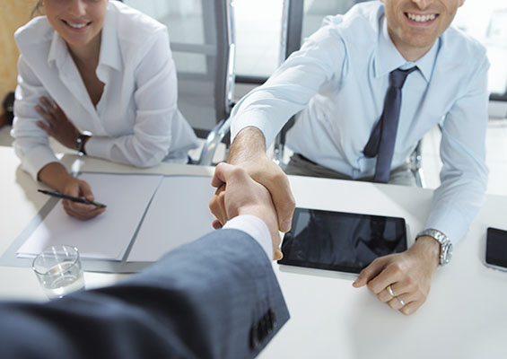 Two people shake hands after a job interview