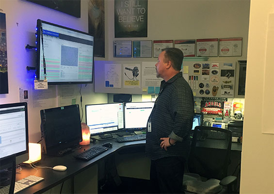 Paul Yoder looks at a monitor in his office