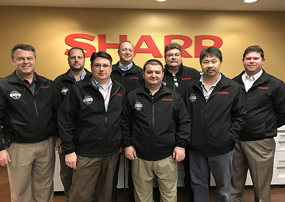Sharp's certified team wearing jackets with the CompTIA Network+ logo