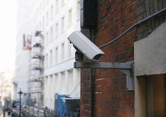 A closed-circuit security camera on a city street.