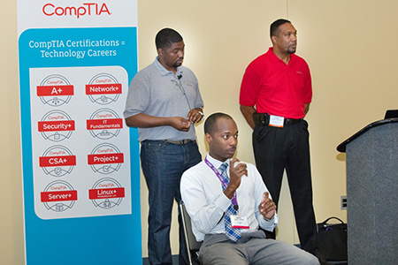 Jonathan Jenkins and Claude Williams of PhoenixTS standing behind the sign language interpreter